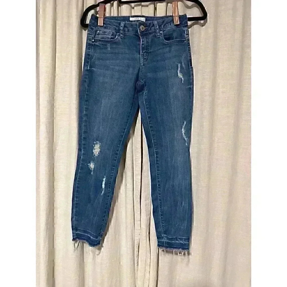 DEX brand size 27 distressed tapered dark blue woman’s jean 85% cotton stretch